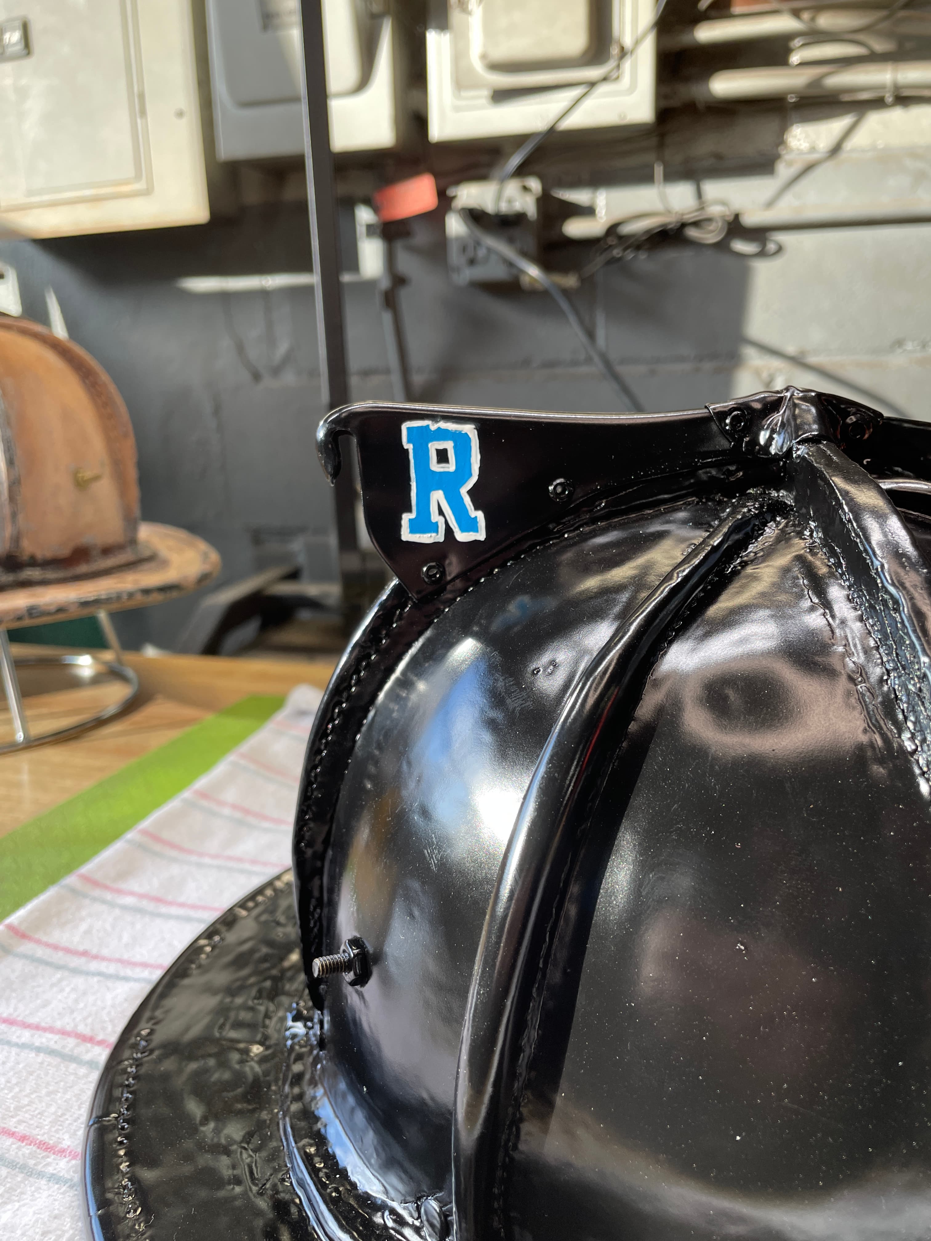 Custom paint and design work on firefighter helmets